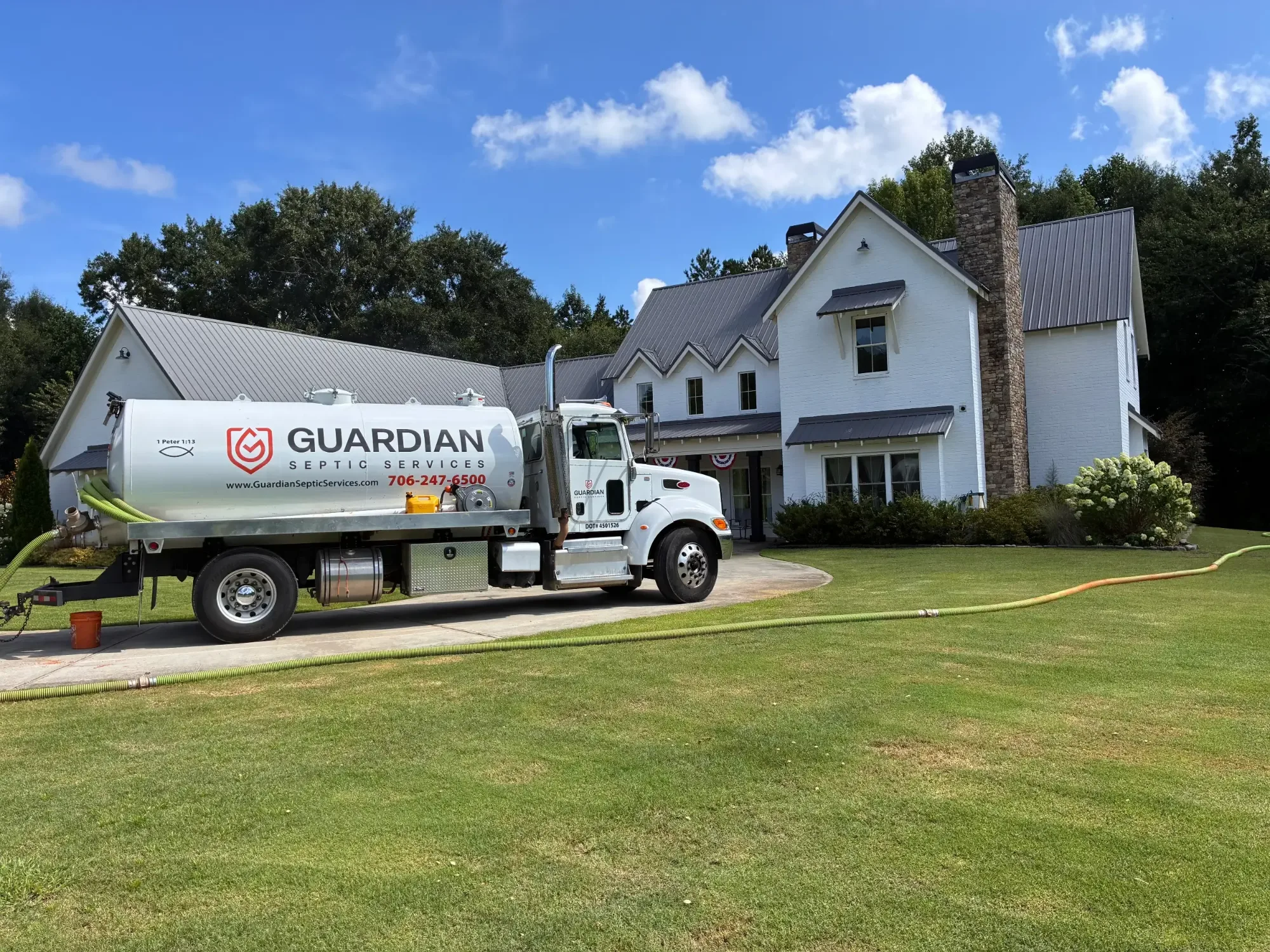 Guardian Septic Services vacuum truck pumping a septic tank at a Toccoa, Georgia home